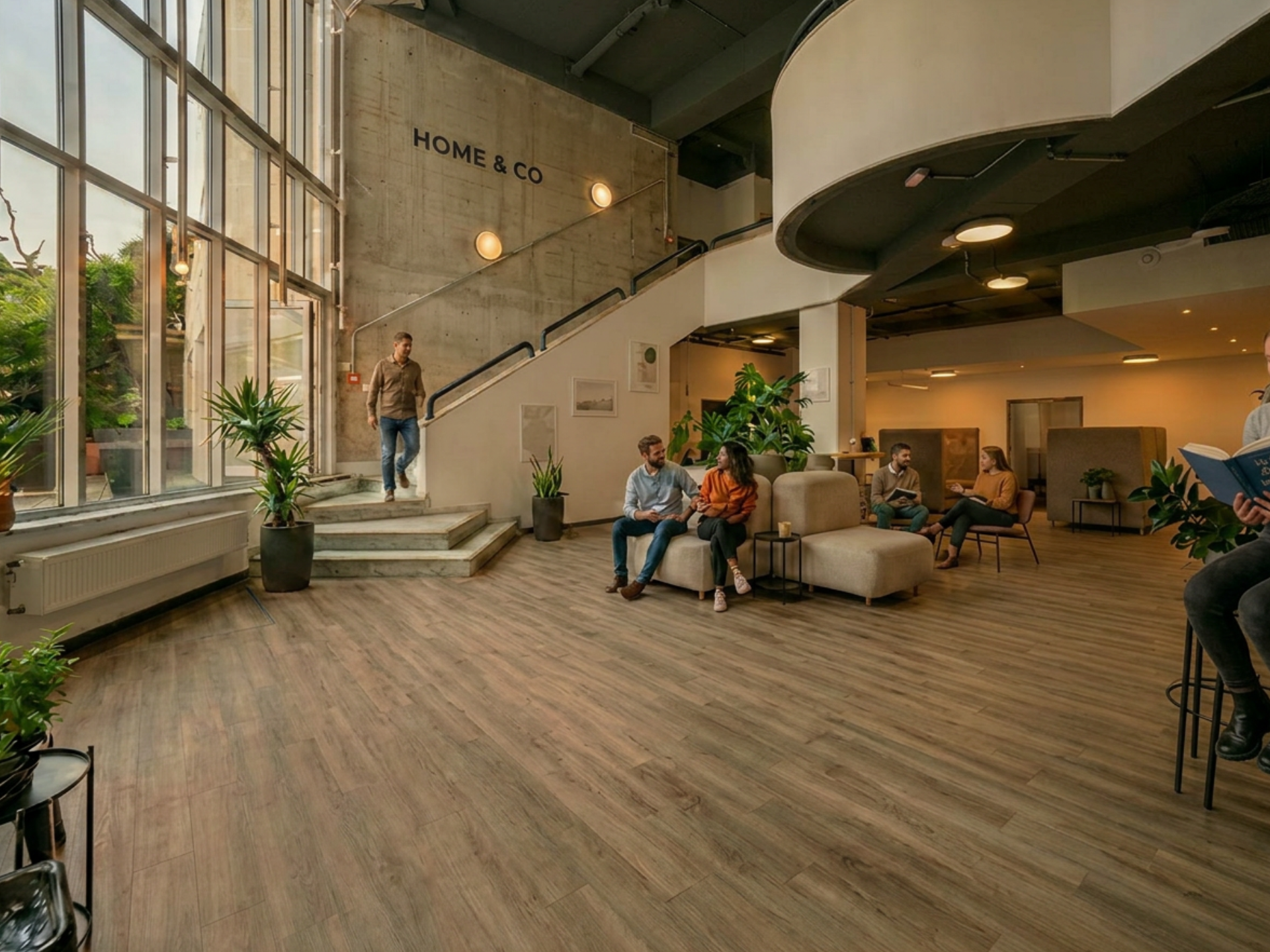 Community lounge with staircase and sofa seating